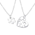 Heart puzzle sterling silver necklace pair on a white background