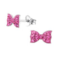 Ribbon crystal sterling silver children's ear studs on a white background.