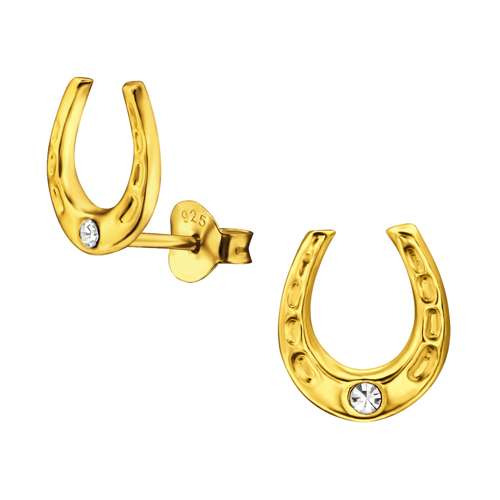 Horseshoe gold ear studs with crystal on a white background