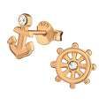 Anchor and wheel rose gold ear studs with crystal on a white background
